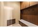 Mudroom features wooden paneling, a built-in bench with drawers, and overhead cabinets at 3553 N Crystal Peak Cir, Mesa, AZ 85207