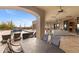 Outdoor patio with a dining area, pool, lounge chairs, and scenic views of the desert landscape at 3553 N Crystal Peak Cir, Mesa, AZ 85207