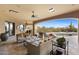 Expansive covered patio featuring cozy seating, a ceiling fan, and stunning views of the pool and surrounding nature at 3553 N Crystal Peak Cir, Mesa, AZ 85207