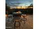 Outdoor patio with wrought iron table and chairs showcasing sunset and city views at 3553 N Crystal Peak Cir, Mesa, AZ 85207