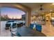 Inviting outdoor patio with a dining table, lounge chairs, pool, and sunset views at 3553 N Crystal Peak Cir, Mesa, AZ 85207