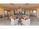 Relaxing covered patio with comfortable seating, ceiling fan, and access to the main house through glass doors at 3553 N Crystal Peak Cir, Mesa, AZ 85207