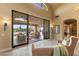 Sunroom features expansive glass doors leading to an outdoor patio with lounge furniture and pool area at 3553 N Crystal Peak Cir, Mesa, AZ 85207