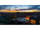 Stunning desert home at dusk featuring a private pool, spa, and captivating city light views at 3553 N Crystal Peak Cir, Mesa, AZ 85207