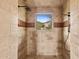 Tiled walk-in shower with a window offering an outdoor view at 3553 N Crystal Peak Cir, Mesa, AZ 85207