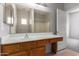 Neutral bathroom featuring a single sink vanity with a large mirror and an open doorway at 3834 W Commonwealth Ave, Chandler, AZ 85226