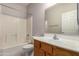 A bathroom with a toilet and tub/shower combination, accompanied by a wooden vanity with a large mirror at 3834 W Commonwealth Ave, Chandler, AZ 85226