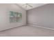 A simple bedroom featuring neutral carpet and paint, a ceiling fan, and a window with horizontal blinds at 3834 W Commonwealth Ave, Chandler, AZ 85226