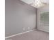 A simple bedroom featuring neutral carpet and paint, a ceiling fan, and a window with horizontal blinds at 3834 W Commonwealth Ave, Chandler, AZ 85226