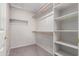 A walk-in closet featuring carpet, shelving, and wooden rods for hanging clothes at 3834 W Commonwealth Ave, Chandler, AZ 85226