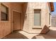 The front entrance area features a light colored stucco exterior, a door and a window at 3834 W Commonwealth Ave, Chandler, AZ 85226