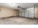 A spacious two car garage with concrete floors and a white overhead garage door at 3834 W Commonwealth Ave, Chandler, AZ 85226