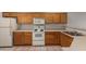 Kitchen features wood cabinets, white appliances and tile flooring at 3834 W Commonwealth Ave, Chandler, AZ 85226