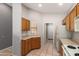 A cozy kitchen featuring wooden cabinets, laminate countertops, white appliances, and tile flooring at 3834 W Commonwealth Ave, Chandler, AZ 85226