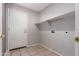 A modest laundry room with tiled floors, washer/dryer hookups, and a single shelf at 3834 W Commonwealth Ave, Chandler, AZ 85226