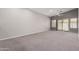 Spacious living room featuring neutral carpet, high ceilings and a sliding glass door at 3834 W Commonwealth Ave, Chandler, AZ 85226