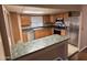 Kitchen featuring wooden cabinets, stainless steel appliances, and a breakfast bar at 4065 E University Dr # 4, Mesa, AZ 85205