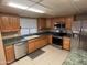 Bright kitchen boasts wood cabinets, stainless appliances and a gray countertop at 4065 E University Dr # 4, Mesa, AZ 85205