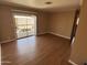 A room with wood floors and a sliding glass door to the outside at 4065 E University Dr # 4, Mesa, AZ 85205