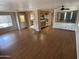Open living room featuring wood floors, lots of natural light, and a built-in cabinet at 4065 E University Dr # 4, Mesa, AZ 85205
