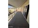 Long carpeted porch with aluminum railing at 4065 E University Dr # 4, Mesa, AZ 85205