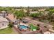Aerial view of the home showing the backyard pool and putting green in a residential neighborhood at 4152 S Bandit Ct, Gilbert, AZ 85297