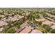 Aerial view showcasing the neighborhood with mature trees and a home with a pool and solar panels at 4152 S Bandit Ct, Gilbert, AZ 85297