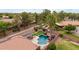 An aerial view of a backyard featuring a pool with a rock waterfall, putting green, and covered patio at 4152 S Bandit Ct, Gilbert, AZ 85297