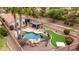 Beautiful backyard with pool, putting green, fire pit, seating area, and desert landscaping at 4152 S Bandit Ct, Gilbert, AZ 85297