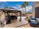 Beautiful backyard featuring a gazebo with bar, and a sparkling pool with tropical landscaping at 4152 S Bandit Ct, Gilbert, AZ 85297