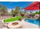 Backyard with pool, putting green, fire pit, and landscaping, great for outdoor activities at 4152 S Bandit Ct, Gilbert, AZ 85297