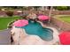 Beautiful backyard with pool and waterfall feature with desert landscaping and string lights at 4152 S Bandit Ct, Gilbert, AZ 85297