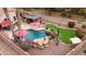 Beautiful backyard with pool, putting green, fire pit, seating area, and desert landscaping at 4152 S Bandit Ct, Gilbert, AZ 85297