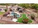 Beautiful backyard with pool, putting green, fire pit, seating area, and desert landscaping at 4152 S Bandit Ct, Gilbert, AZ 85297