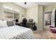 Bedroom featuring a bed, desk, and ceiling fan, offering a comfortable and functional space at 4152 S Bandit Ct, Gilbert, AZ 85297