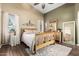 Cozy bedroom featuring natural light, wood flooring, and a comfortable bed with a ceiling fan at 4152 S Bandit Ct, Gilbert, AZ 85297