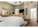 Relaxing bedroom with a wood bed frame, ensuite bathroom and a dresser with mirror at 4152 S Bandit Ct, Gilbert, AZ 85297