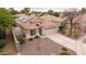 Aerial view of a single Gathering house with a three car garage and solar panels at 4152 S Bandit Ct, Gilbert, AZ 85297