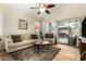 Cozy living room featuring comfortable seating, a ceiling fan, and sliding doors leading to the backyard at 4152 S Bandit Ct, Gilbert, AZ 85297