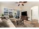 Comfortable living room with backyard view, ceiling fan, and a media center for entertainment at 4152 S Bandit Ct, Gilbert, AZ 85297