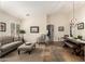 Inviting living room with a comfortable couch, ottoman and lots of light at 4152 S Bandit Ct, Gilbert, AZ 85297