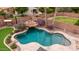 A dazzling pool features a built-in rock waterfall and beautifully landscaped backyard at 4152 S Bandit Ct, Gilbert, AZ 85297