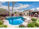 The backyard features a beautiful pool with desert landscaping, rocks, and a covered gazebo at 4152 S Bandit Ct, Gilbert, AZ 85297