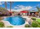 The backyard features a beautiful pool with desert landscaping and a rock waterfall at 4152 S Bandit Ct, Gilbert, AZ 85297