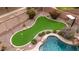 Putting green with flags, desert landscaping, and decorative lights at 4152 S Bandit Ct, Gilbert, AZ 85297