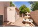 Charming backyard with storage shed, mature tree, and decorative fountain at 4201 W Renee Dr, Glendale, AZ 85308