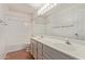 Bathroom with wood look floors, double sinks, and a bathtub with shower at 4201 W Renee Dr, Glendale, AZ 85308