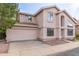 Two-story home featuring a two car garage, stucco exterior, and desert landscaping at 4201 W Renee Dr, Glendale, AZ 85308