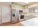 Well-lit kitchen with stainless steel refrigerator, white cabinetry and plenty of counter space at 4201 W Renee Dr, Glendale, AZ 85308