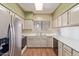 Bright kitchen features stainless steel appliances, ample cabinet space, and laminate floors at 4201 W Renee Dr, Glendale, AZ 85308